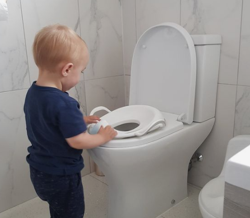 look,my baby started playing with toilet commode