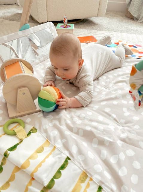 my sister try to involve her 3 months old during tummy time with occupied play.